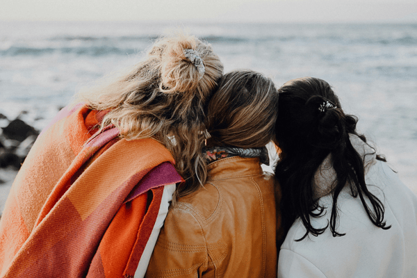 women hugging from a travel community